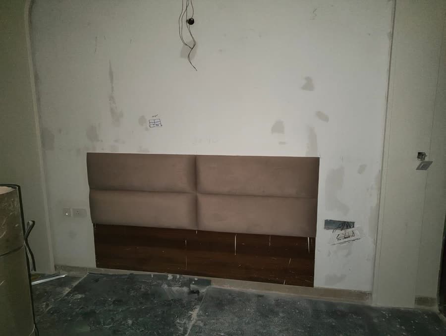 Upholstered headboard wall in the bedroom
